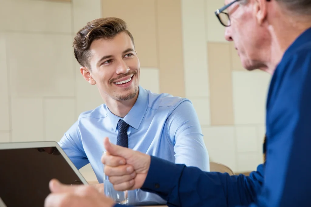 smiling businessman listening senior man
